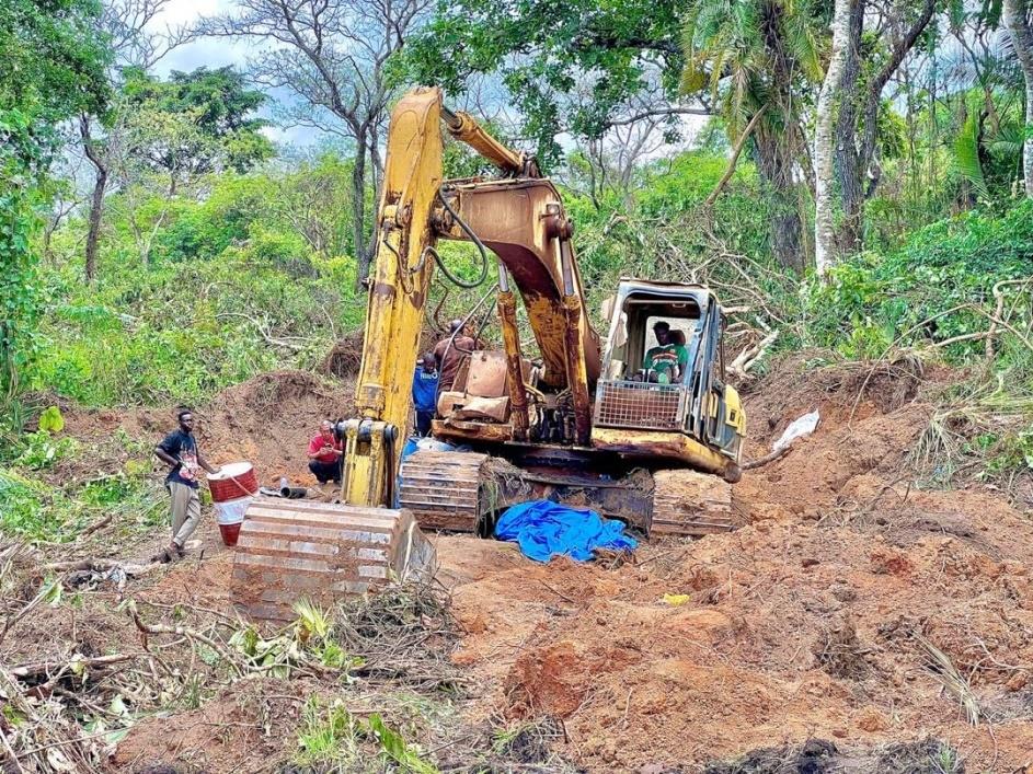 Tracked excavator working an alluvial gold mining pit at a MOUHDJAF site in Cameroon