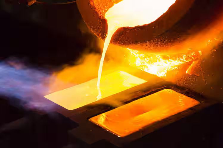 Molten gold being poured into a bar mold at 1600 degrees